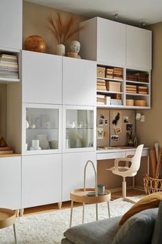 a living room filled with furniture and lots of shelves on top of eachother