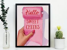 a pink poster with the words hello, sweet cheeks on it next to a potted plant