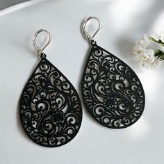 Experience the elegance and compatibility of our large stainless steel drop-shaped earrings. These impressive earrings are 7 cm long and impress with their unique ornamental design and strong color. The earrings are fitted with stainless steel ear hooks, which ensure a high level of comfort and are particularly skin-friendly. Our earrings are nickel-free and will not discolour, making them ideal for those with sensitive skin. The eye-catching design makes them the perfect accessory for special o Elegant Black Metal Teardrop Earrings, Black Stainless Steel Dangle Earrings, Black Metal Drop Earrings, Black Metal Teardrop Earrings, Black Teardrop Metal Earrings, Black Pierced Chandelier Earrings As Gift, Black Pierced Chandelier Earrings For Gift, Black Chandelier Earrings As Gift, Black Laser Cut Jewelry As Gift