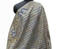 Pattern - Sanskrit chants scarf. OM and Gaytri mantra is written on the scarf. Ideal for -  unisex. Occasion -   formal or casual. Fabric - khadi handoom.It is hand-woven block and screen printed. Color - Beige. On the beige background, OM and Gayatri mantra is written in blue and golden color. On two sides one-inch velvet blue lace is stitched which highlights the border. A beautiful piece from Indian handloom. Can be wrapped in different styles. Size - 36 x 92 inches. Care - gentle hand wash. Traditional Scarf For Festivals As A Gift, Traditional Scarves For Festivals As Gifts, Meditation Shawl, Personalized Scarves, Big Scarf, Orange Scarf, Embroidered Scarf, Winter Shawl, Vintage Silk Scarf