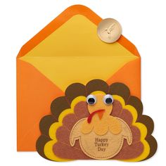 an orange envelope with a turkey on it and a gold coin in the front pocket