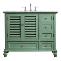 a green bathroom vanity with two sinks and shuttered doors on the front, against a white background