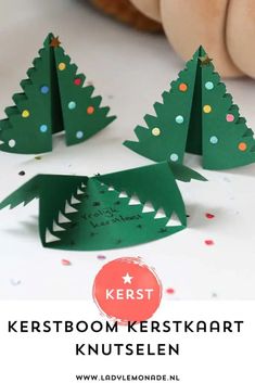 three paper christmas trees with the words kerstboom kerstkrart written on them