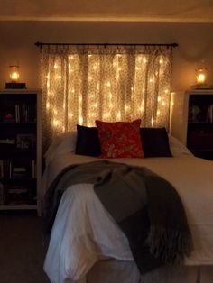 a bedroom with lights on the headboard and bed