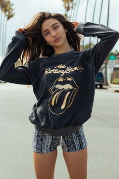 FREE SHIPPING ON ORDERS OVER $60 Don't miss out on this exclusive Rolling Stones Sticky Fingers Sweatshirt! Show off your rock 'n' roll spirit in style with this eye-catching graphic sweatshirt featuring a cool gold foil print. The relaxed fit and super soft organic cotton make it cozy and easy to wear, so you can rock out in comfort! Color: Black Fabric: 100% Organic Cotton Model wears a small Made in Los Angeles