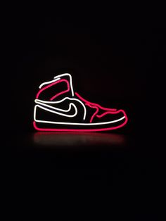 a pair of sneakers is lit up in the dark with red and white neon lights