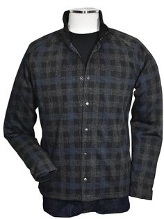 Introducing the Marcello Terrio Button Front Shacket, the perfect combination of style and functionality. This shirt jacket features a classic mock collar and snap enclosure, along with open sleeve cuffs and a waist band for a comfortable fit. The rich black base color is accented with a charcoal plaid pattern and a pop of royal blue. A mix of cotton, viscose and microfiber for a soft, light weight garment. Tubular cuffs and waist band add contemporary cool style. The model is perfect for a slim Stand Collar Shirt With Buttons For Fall, Fall Shirt With Stand Collar And Buttons, Semi-formal Shirt With Button Closure For Fall, Stand Collar Shirt With Button Closure For Work, Winter Workwear Shirt With Snap Buttons, Formal Winter Shirt With Button Closure, Winter Formal Shirt With Button Closure, Button-up Outerwear With Snap Cuffs For Work, Workwear Button-up Outerwear With Snap Cuffs