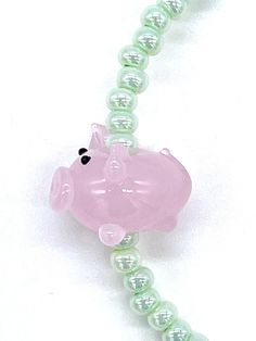 "This Pink Piglet beaded stretch bracelet gift set is handmade in the U.S.A. The mint green glass seed beads are size 6/0 and have a pearlized luster. They're strung on a one size fits all stretchy cord next to a single featured lampwork glass pig bead. The gift comes just as pictured with one bracelet, one card, and one jewelry bag. As they are each handmade, very slight variations will occur, which increases the value of each piece. Buying handmade from the U.S.A. means you get the most affordable and the fastest shipping. This gift is boxed and ships free with USPS first class mail. With ThisBeadCo.'s included signature poem this bracelet becomes an affordable gift with great meaning. The poem card reads, \"This bead is me is a sea of conformity. I will stand out, there is no doubt. And Seed Bead Bracelet, Jewelry Bag, Minimalist Bracelet, Affordable Gifts, Seed Bead Bracelets, Buy Handmade, Beaded Stretch Bracelet, Jewelry Bags, Bead Bracelet