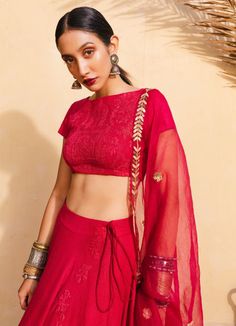 A red bohemian bridal lehenga with a silk blouse embroidered with moroccan detail with a handwoven silk circle lehenga, a red hand woven organza dupatta embroidered in tribal moroccan motifs in hammered gold All our blouses can be customised for sleeves, neck design and length. An additional Net Dupatta can be added from our Dupatta Collection Composition: Silk , Organza All products can be customised for sleeves, length of blouse and neck design Delivery : 6-8 weeks as the product is hand craft Transitional Red Lehenga With Sheer Dupatta, Transitional Red Choli With Sheer Dupatta, Red Bohemian Chanderi Sets, Bohemian Pre-draped Saree With Resham Embroidery For Navratri, Bohemian Choli With Sheer Dupatta For Festive Season, Red Semi-stitched Bohemian Anarkali Set, Bohemian Sharara With Dupatta For Reception, Bohemian Traditional Wear With Sheer Dupatta, Bohemian Blouse For Reception