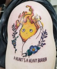 a person with a tattoo on their arm that says, a heart's a heavy burden