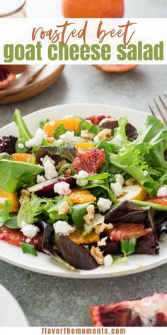 a white plate topped with salad next to oranges