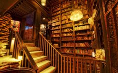 an old library with wooden bookshelves and stairs