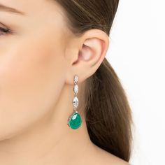 Steal the spotlight with the Zara Teardrop Colombian Emerald Gemstone Earrings in Silver. These stunning pieces boast a captivating pear-shaped lab-created emerald set in a beautifully detailed silver frame, highlighted by a row of three marquis-shaped simulated diamonds for an extra dash of elegance.  Emeralds, known for their rich green hue, are not just May's birthstone but also symbols of rebirth, love, and wisdom. Whether you're dressing to impress at a gala or adding a sophisticated touch Luxury Teardrop Earrings For Party, Elegant Gemstone Chandelier Earrings With Long Drop, Elegant Long Drop Gemstone Chandelier Earrings, Elegant Long Drop Chandelier Earrings With Gemstone, Teardrop Gemstone Bridal Earrings, Teardrop Gemstone Bridal Earrings For Party, Wedding Gemstone Teardrop Earrings, Wedding Teardrop Gemstone Earrings, Formal Gemstone Pear-shaped Teardrop Earrings