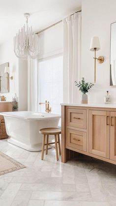 a bathroom with a tub, sink and mirror in it's centerpieces