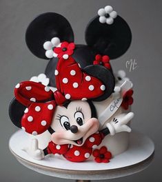 a mickey mouse cake with red and white polka dots