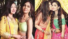 two women in sari are posing for the camera and one is kissing her friend