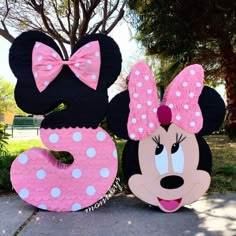 two minnie mouses are standing next to each other