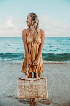 Beige Tassel Dress For Vacation, Chic Beach Dresses With Tassel Ties, Brown Summer Mini Dress For Beach, Chic Fringe Mini Dress For The Beach, Beige Beach Dress With Tie Back, Beige Tie Back Dress For Beach, Beach Sundress With Tassels, Beige Tie-back Beach Dress, Casual Beach Mini Dress With Tassels