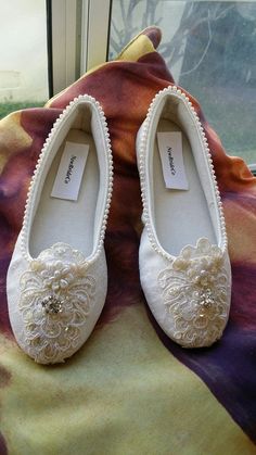 "READY TO SHIP SHOES USA SIZE: 5, AS SHOWN IN PICTURE. COLOR: IVORY SIZE: 5 Brides Ivory Flat Shoes Elegantly embelished with hand sewn pearls edging, exquisite flowers appliqués, and an all over inside thick padding for super comfort. Safe to wear, non-slippery outer sole for indoors, or outdoors dry safe areas. THESE VEGAN SHOES RUN SLIGHTLY SMALLER THAN MY OTHER SHOES, YOU MAY GO UP TO THE NEXT SIZE, OR CONTACT FOR INSTEP LENGTH MEASUREMENT AND A SIZE CHART FOR THESE SHOES. REMEMBER THESE SHO Cream Embellished Round Toe Wedding Shoes, Embellished Cream Wedding Shoes With Round Toe, Cream Embellished Wedding Shoes With Round Toe, Ivory Flats, Ivory Shoes, Wedding Flats, Length Measurement, Sequin Appliques, Womens Wedding Shoes