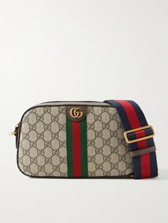 Gucci's 'Ophidia' bags have been a brand signature since they first debuted in 2018. Perfectly sized to fit your everyday essentials, this version has been crafted in Italy from monogrammed coated-canvas and detailed with striped webbing, leather trims and gold-tone 'GG' hardware. Gucci Leather Shoulder Bag With Gold-tone Hardware, Gucci Shoulder Bag With Gold-tone Logo Plaque, Messenger Bag For Men, Gucci Monogram Canvas Shoulder Bag With Gold-tone Hardware, Gucci Shoulder Bag With Gold-tone Hardware And Double Handle, Gucci Collection, Gucci Ophidia, Gucci Canvas Bags With Gold-tone Hardware, Ultimate Gift Guide