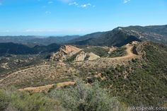 a scenic view of the hills and valleys in the distance with trees on each side