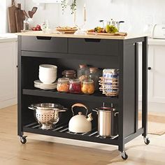 a kitchen island with pots and pans on it