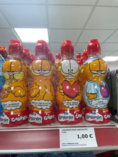 several bottles of orange juice on display in a store