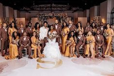 a large group of people posing for a photo in front of a wedding arch with the bride and groom