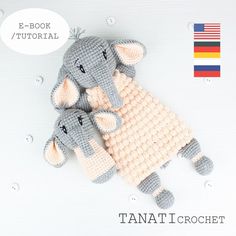 two crocheted stuffed animals laying next to each other on top of a white surface