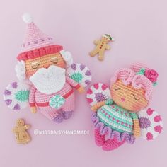 two crocheted dolls sitting next to each other on a pink surface with a teddy bear