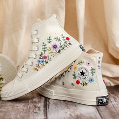 Custom Bridal Flowers Embroidered Sneakers for Wedding, Flowers Embroidered Converse for Bride, Flowers Embroidered Shoes Custom, Wedding Gifts 💚 Immerse yourself in the intricate craftsmanship as we lovingly hand embroider rustic flowers onto your chosen Converse pair 💚 🌿 The listed price encompasses both the Converse Shoes and the showcased Embroidery Designs. 1. MANUFACTURING PROCEDURE 🌿 Upon receiving your order, we initiate the shoe preparation process. If your chosen shoes are readily Embroidered Sneakers For Wedding, Embroidered Closed Toe Sneakers For Spring, Embroidered Sneakers For Spring, Spring Embroidered Sneakers, Wedding Low-top Sneakers With Floral Embroidery, Spring Sneakers With Multicolor Embroidery And Appliques, Spring Wedding Embroidered Sneakers, White Sneakers With Appliques For Summer, High-top Multicolor Embroidered Sneakers