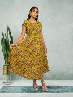 Embrace elegance with our Tranquil Threads yellow knee-length dress. Featuring a stunning print, this dress is perfect for everyday wear or a night out in the city. Crafted with care for the modern woman who values both comfort and style. Key Specifications : Material Kalankari Silk Occasion Casual Type Fusion/Indowestern V-neck Kalamkari Print Dresses For Festive Occasions, Festive Sleeveless Floral Print Dress, Knee-length Printed Sundress, Festive Floral Print Midi Dress, Festive Knee-length Dresses, Printed Flowy Midi Dress, Flowy Printed Midi Dress, Elegant Yellow Dress With Printed Motifs, Fitted Midi Dress For Festive Occasions