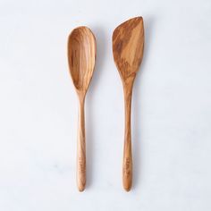 two wooden spoons sitting next to each other