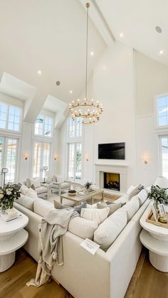 a living room filled with furniture and a fire place in the middle of two windows