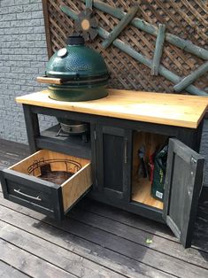 an outdoor bbq table with drawers on it