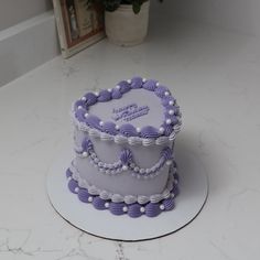 a three tiered cake sitting on top of a white counter