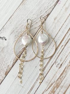 The Alohi Earrings are made with 14 kt gold fill teardrop shaped hoops, ear wire and sparkly gold fill chain accents. The focal in the middle is a luminous white coin pearl and gold fill bead.  These earrings hang about 2 1/2"down from the bottom of the ear wire with the chain and 1 1/8" wide. *All of our pearls are natural and therefore, one of a kind. Each pearl will have variations in color/surface/shape that may not be exactly as shown in the image. This makes each piece of jewelry truly uni Collage Elements, Metal Circle, Coin Pearls, Gold Filled Chain, Ear Wire, Earrings Gold, Wire Jewelry, Jewelry Earrings Dangle, Gold Earrings