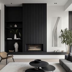 a modern living room with black and white decor on the walls, fireplace and shelves