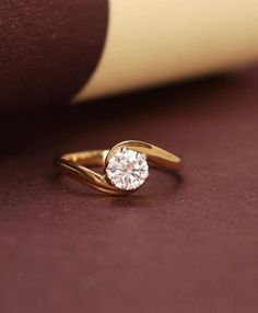 a diamond ring sitting on top of a book