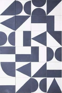 an abstract tile design with black and white shapes