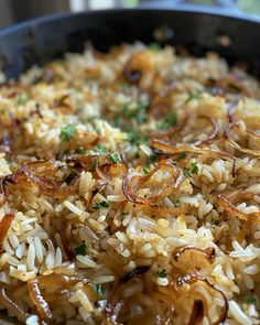 rice with onions and parsley in a skillet