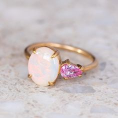 Our Bud Ring is set with a crystal opal and pink pear shape sapphire. Opal measures 10 x 8mm. Sapphire measures 6 x 4mm. Band width 1.8mm. Gold weight in 14ct 3.8 grams approx. Please note, we will match the opal as close to the image as possible. Each opal is unique and may vary in appearance and colour from what is depicted on the site. Pictured with a matte finish. For a high shine finish, please leave a note at checkout. Sarah Gardner, Crystal Opal, My Size, Opal Ring, Opal Crystal, Pink Opal, Fine Jewellery, Opal Rings, Pear Shape