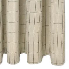 a window curtain with a checkered pattern on it's side and the top half closed