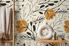 the wallpaper is decorated with orange flowers and black leaves on white, brown, and yellow colors