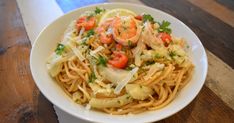 a white bowl filled with pasta and vegetables