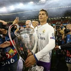 real madrid's forward cristianoo celebrates with the trophy in front of fans