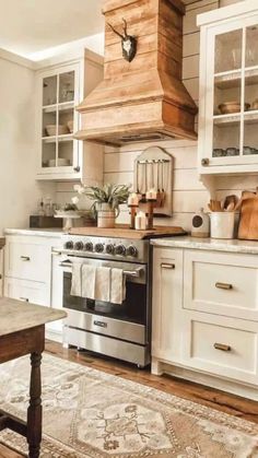 a kitchen with white cabinets and an old fashioned stove top oven in the middle of it