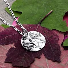 This is a silver necklace featuring a wolf howling at the moon. We use moldable silver which we shape into our designs. After firing at 1200F it is 99.9% pure silver. This pendant is compared to a penny in the picture for you to get a sense of its size. Please see our video also which features the product up close! We offer multiple stainless steel chain sizes that go with this pendant in the options. We sell real silver chains separately as well. Please message us if you would like to purchase Relationship Jewelry, Wolf Howling At The Moon, Howling At The Moon, Wolf Necklace, Howl At The Moon, Howling Wolf, Forest Creatures, Couple Necklaces, Silver Chains