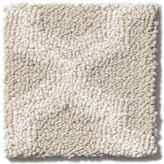 a white carpet textured with lots of small dots on the bottom, and an area that looks like it has been made out of wool