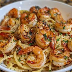 pasta with shrimp and parmesan cheese in a white bowl